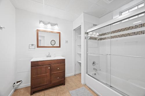a bathroom with a shower and a sink and a mirror at Shadyside, Pittsburgh !D Modern and Bright Private Bedroom with Shared Bathroom in Pittsburgh