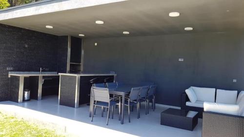 a patio with a table and chairs and a bar at Varandas do Castelo in Celorico de Basto