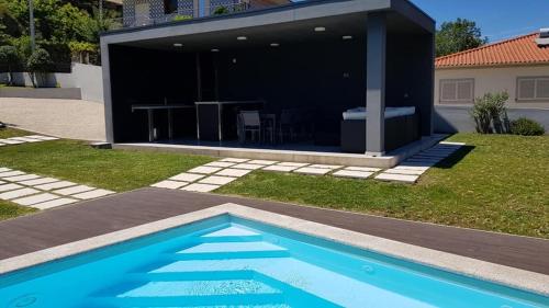 a house with a swimming pool in a yard at Varandas do Castelo in Celorico de Basto