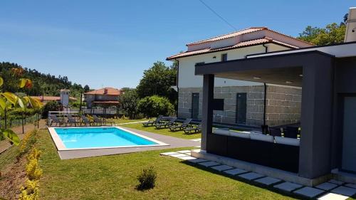 a house with a swimming pool in the yard at Varandas do Castelo in Celorico de Basto