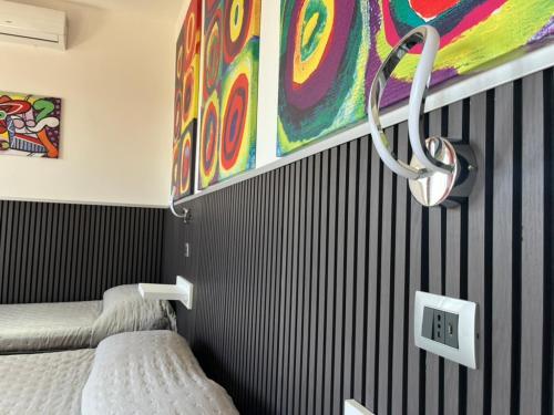 a room with two beds and a painting on the wall at Soverato Sweet Home 13 in Soverato Marina