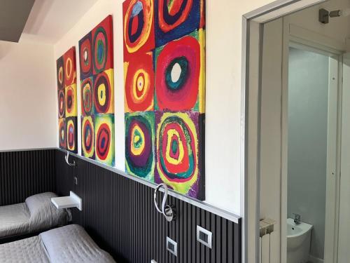 a bathroom with a painting on the wall at Soverato Sweet Home 13 in Soverato Marina