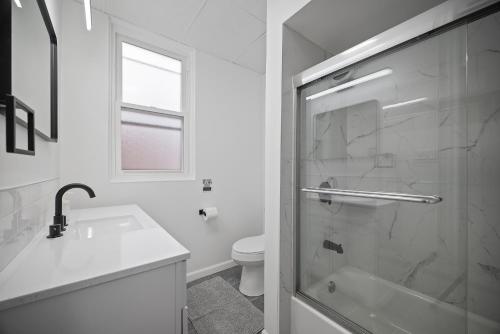 a bathroom with a shower and a sink and a toilet at Shadyside, Pittsburgh !E Modern and Bright Private Bedroom with Shared Bathroom in Pittsburgh