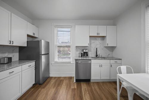 a kitchen with white cabinets and stainless steel appliances at Shadyside, Pittsburgh !E Modern and Bright Private Bedroom with Shared Bathroom in Pittsburgh