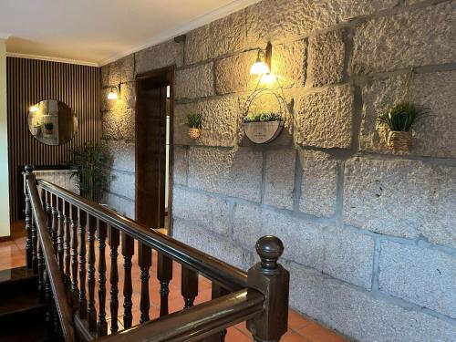a stone wall with a staircase with potted plants on it at Refúgio da Barragem in Vale de Anta