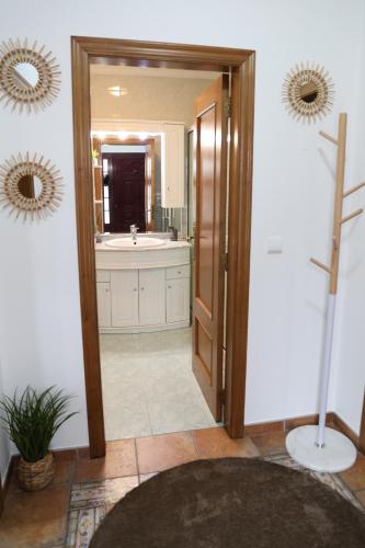 a bathroom with a tub and a large mirror at Refúgio da Barragem in Vale de Anta