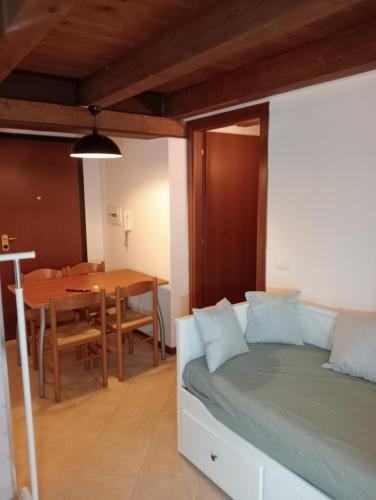 a bedroom with a bed and a dining table at Casa Meli in Passo del Tonale