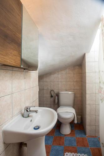 a bathroom with a sink and a toilet at Ennisfree Villa in Kiotari