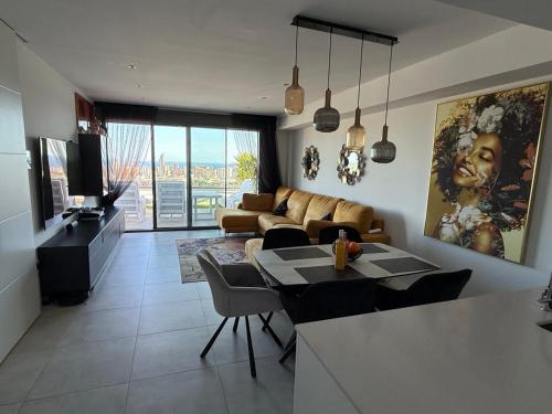 a living room with a couch and a table at SUNNY home in Finestrat