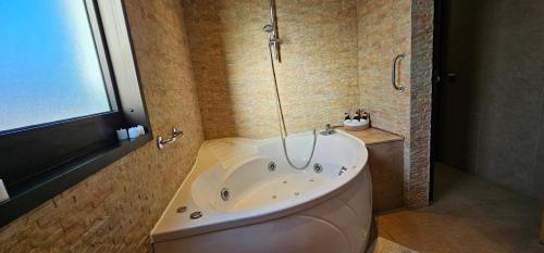 a bath tub in a bathroom with a shower at Wonderful Sea Views by Vapagó Tenerife in Costa Del Silencio