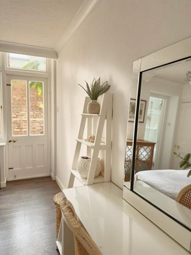 a mirror sitting on a table in a bedroom at Verulam Palms - Private Garden & Parking in Bournemouth