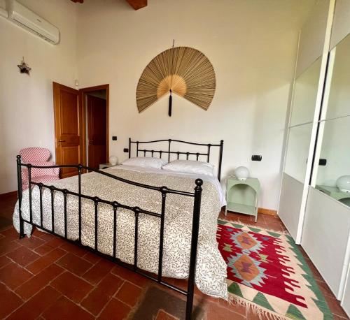 a bedroom with a large bed with a umbrella at Casa Bigallo - colline di Firenze in Bagno a Ripoli