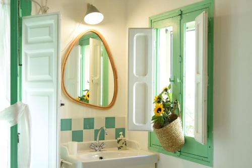 a bathroom with a sink and a mirror at Casina Panta Rhei in Scicli