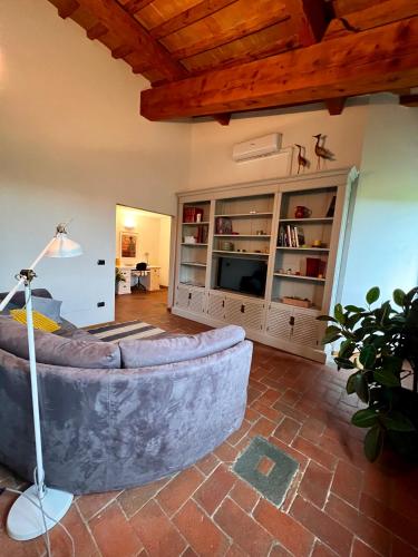 a living room with a couch and a table at Casa Bigallo - colline di Firenze in Bagno a Ripoli