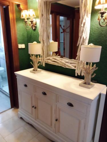 a bathroom with a white vanity with a mirror at Errotaetxe Mundaka in Mundaka