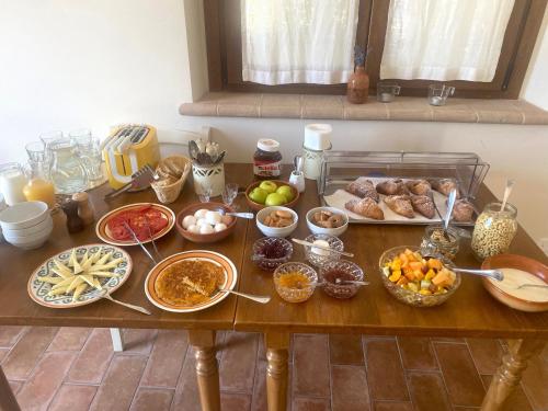 a table with many different types of food on it at Agriturismo Colle Mura in Morano Madonnuccia