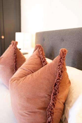 a pair of pillows sitting on a bed at Aan d'Oewer in Citrusdal