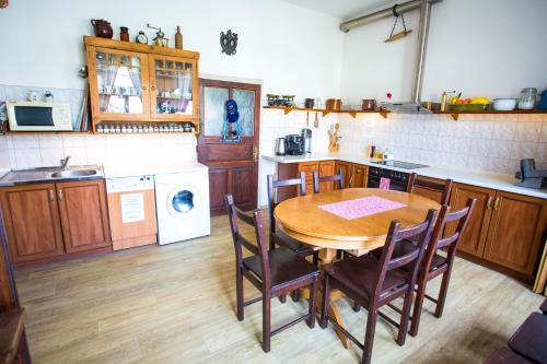 a kitchen with a wooden table and chairs in it at Penzion Ctrnactka in Rataje nad Sázavou