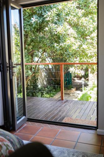 an open sliding glass door to a deck at Aan d'Oewer in Citrusdal