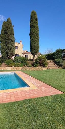 a swimming pool in the middle of a yard with trees at PassionToscane in San Giovanni dʼAsso