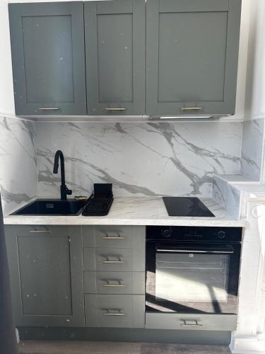 une cuisine avec un évier et un plan de travail dans l'établissement Les Oliviers - Centre ville de Saumur, à Saumur