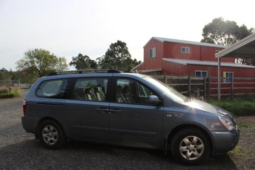 a small blue car parked in a parking lot at Dixiglen Farm in Dixons Creek