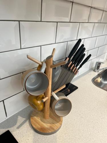 a kitchen counter with a bunch of cooking utensils at Gorgeous little gem in London