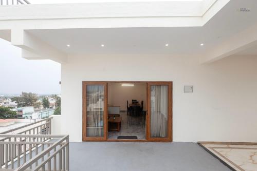 a view from the balcony of a white house at The Aetheria Service Apartment in Chikmagalūr