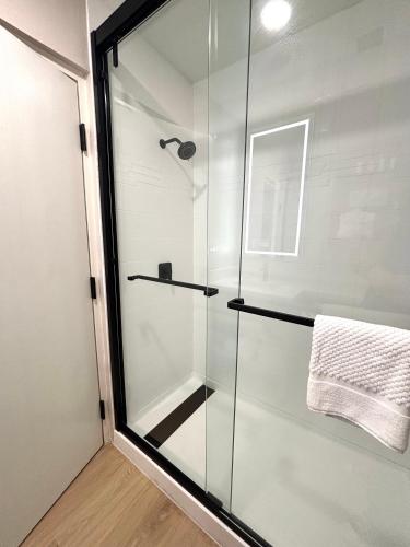 a shower with a glass door in a bathroom at Ramada by Wyndham Davenport Orlando South in Davenport