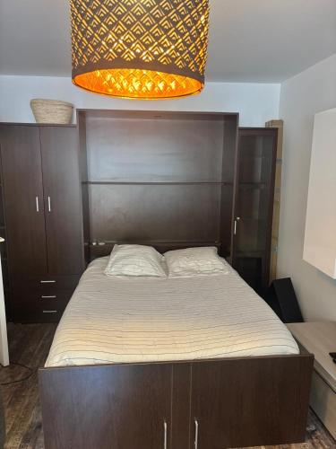 - un lit avec une tête de lit en bois dans l'établissement Studio cosy à 400m de la plage - Lumineux et comfortable, à Menton