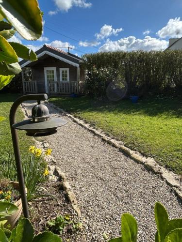 a garden with a birdbath in front of a house at Oudoty in Kerlouan