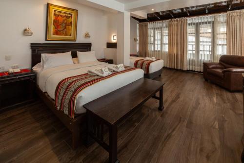 a hotel room with a bed and a couch at Gringo Bill's Boutique Hotel in Machu Picchu