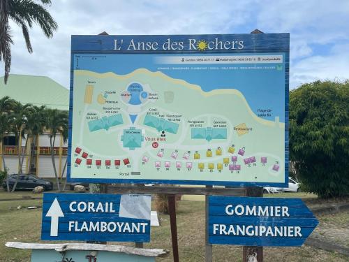 a sign for a resort with a map at studio Ti’Gwada Family in Saint-François