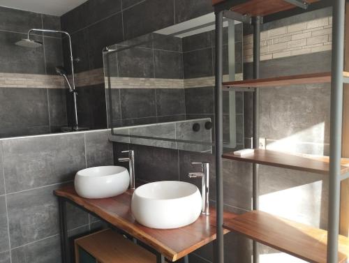 a bathroom with two sinks on a wooden shelf at L'Echapée belle in Le Bourg-dʼOisans
