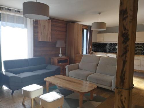 a living room with a couch and a table at L'Echapée belle in Le Bourg-dʼOisans