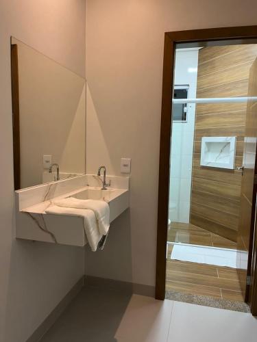 a bathroom with a sink and a shower at Pousada Vilhena in Vilhena