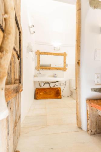 a bathroom with a sink and a mirror at Maison De Yaya at Heraion Lagoon in Loutraki