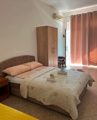 a bedroom with a large bed with two towels on it at Villa Savovic in Petrovac na Moru