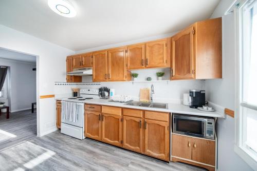 a kitchen with wooden cabinets and white appliances at 2 Bedroom Home In A Prime Location in Winnipeg
