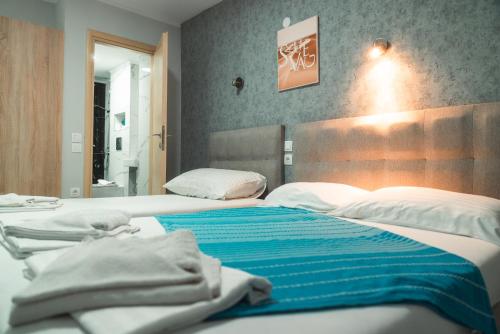 a bedroom with two beds with towels on them at Aktis Sea View Studios in Perea