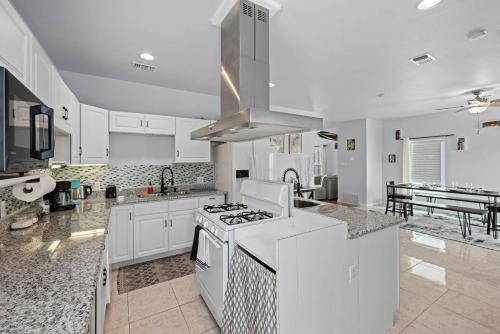a kitchen with white cabinets and a stove top oven at Near Downtown Heights Apt Yard Terrace WiFi Desk in Houston