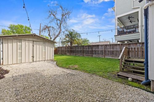 a house with a wooden fence and a yard at Near Downtown Heights Apt Yard Terrace WiFi Desk in Houston