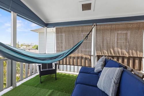a blue couch on a balcony with a hammock at Near Downtown Heights Apt Yard Terrace WiFi Desk in Houston