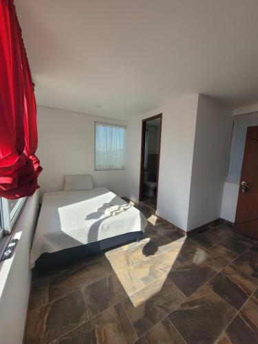 a bedroom with a bed and a tiled floor at Centro Recreativo Las Palmeras in Gachancipá