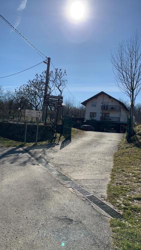 a dirt road with a house in the background at Apartman Denis Una in Lužine