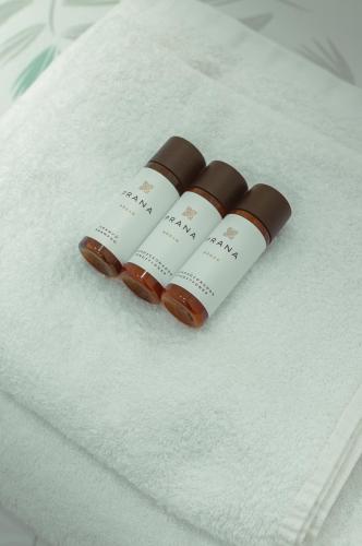 two medicine bottles sitting on top of a bed at Only for Women Hostel Madrid-Sol in Madrid
