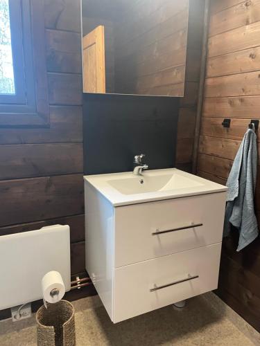 a bathroom with a white sink and a mirror at Barlindbotn feriehytte med båtutleige in Kvalsvik