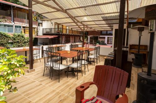 a restaurant with tables and chairs on a patio at Gringo Bill's Boutique Hotel in Machu Picchu