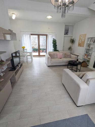 a living room with two couches and a tv at House in Gardos in Zemun