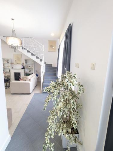 a living room with a staircase and a couch at House in Gardos in Zemun